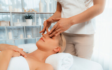Caucasian woman enjoying relaxing anti-stress head massage and pampering facial beauty skin...