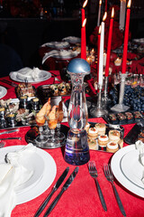 Luxury Table & Tequila Elegant festive table setting with premium tequila bottles, red accents, and gourmet treats. Ideal for upscale events and celebrations.