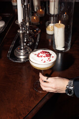 Elegant cocktails served during a festive evening event. A blend of vibrant drinks, stylish settings, and classy table arrangements with red elements.