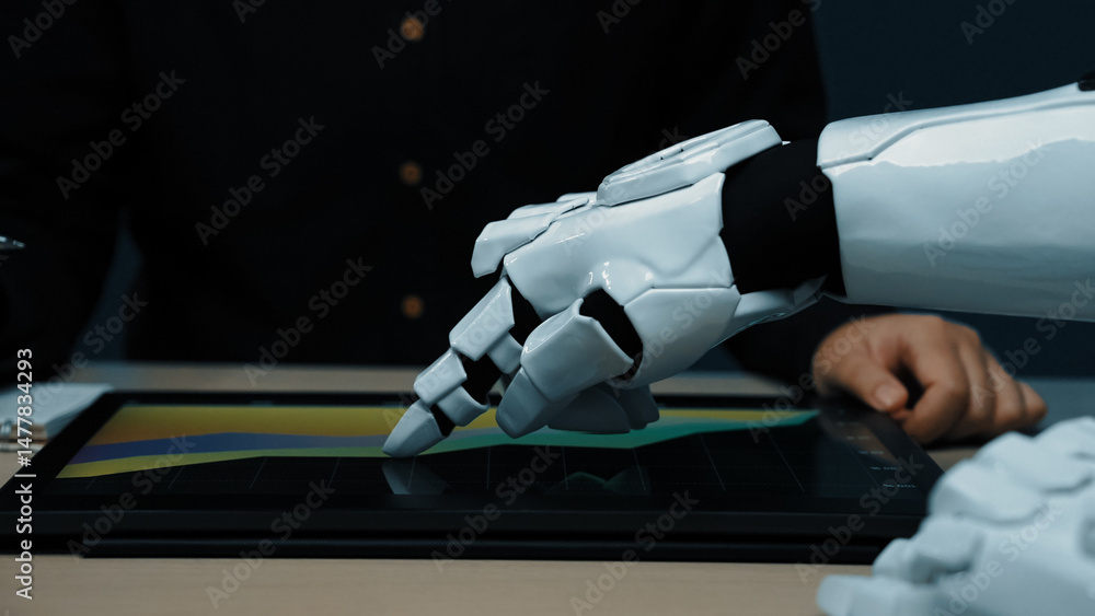 Poster a robotic hand engaged with a digital tablet on a modern workspace, showcasing the intersection of t
