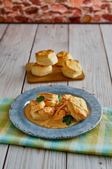 shrimp creole seafood bisque with biscuits on a blue/green napkin