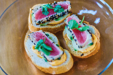 Sesame crusted ahi tuna bites on toast points