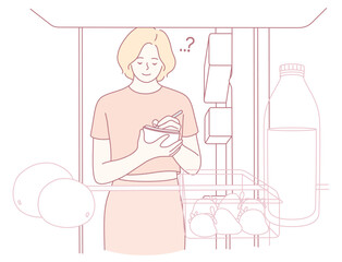 A woman is thoughtfully considering her various grocery choices in a fridge brimming with many options