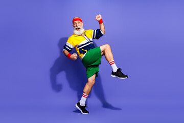 Elderly man enthusiastically performing a vintage style fitness routine in retro clothing with...