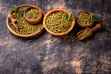 Raw uncooked mung beans on black background
