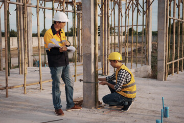 A team of engineers wearing hard hats inspect construction and inspect the site to ensure quality and compliance with design specifications, safety standards and project requirements.