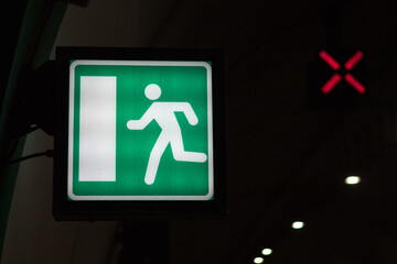 Emergency exit sign illuminated during nighttime in a building