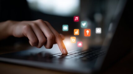 A hand interacts with a holographic interface, highlighting icons related to digital marketing while using a laptop, emphasizing modern technology in business