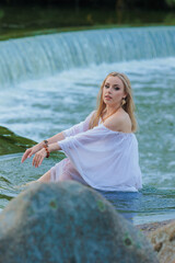 Beautiful Girl with long hair swims and dances in water