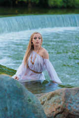 Beautiful Girl with long hair swims and dances in water