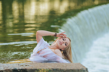 Beautiful Girl with long hair swims and dances in water