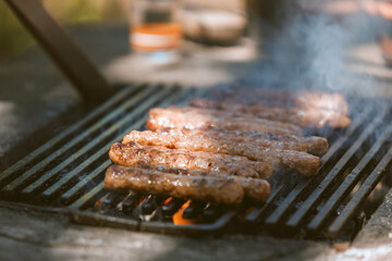 Grilling delicious steak strips on an outdoor barbecue
