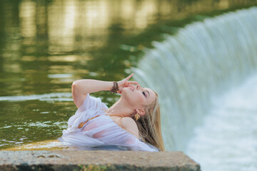Beautiful Girl with long hair swims and dances in water