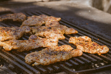 Juicy steaks grilling over charcoal at a summer barbecue