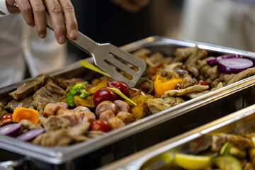 Delicious assortment of grilled meats and colorful vegetables served at a buffet