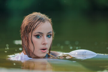 Beautiful Girl with long hair sitting in water