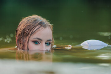 Beautiful Girl with long hair swims and dances in water