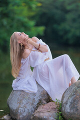 Obraz premium Beautiful Girl with long hair swims and dances in water