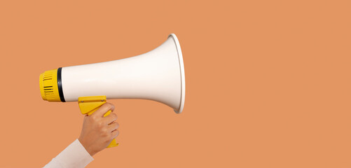 Announcement of a rally or protest in an urban setting using a megaphone to gather attention and voice community concerns