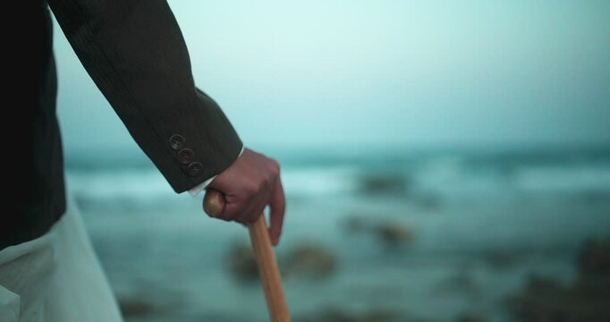 Philosophical Old Man by the Seashore with Waves Touching His Feet