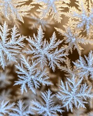 Image shows intricate macro close-up detail of beautiful shimmering ice frost crystals forming delicate natural winter patterns.