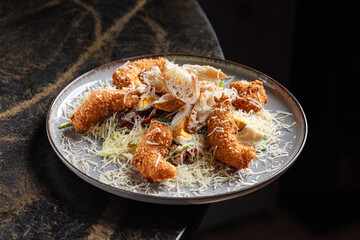 Shrimp Caesar Salad – Classic Caesar salad topped with crispy breaded shrimp, fresh romaine lettuce, cherry tomatoes, croutons, and grated parmesan, served with Caesar dressing.