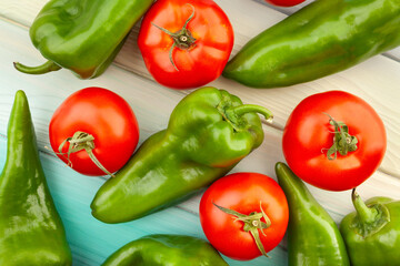 sweet green pepper tomato mix on wood background top view
