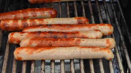 Sausages are grilling beautifully to perfection, showcasing an absolutely delicious barbecue experience for all