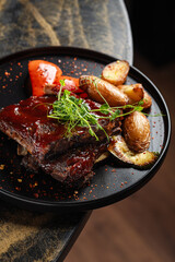 BBQ Ribs with Roasted Vegetables – Juicy barbecue-glazed pork ribs served with crispy roasted baby potatoes, grilled zucchini, and red pepper.