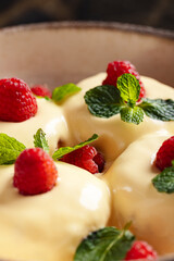 Syrniki with Vanilla Sauce and Raspberries.
Classic cottage cheese pancakes topped with creamy vanilla sauce, fresh raspberries, and mint leaves — a beloved Eastern European dessert.
