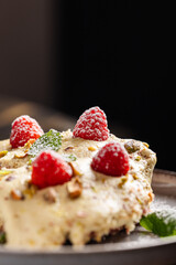 Ricotta Cheesecake with Raspberries & Pistachio.
Light ricotta-based cheesecake slice, topped with fresh raspberries, crushed pistachios, powdered sugar, and mint leaves.