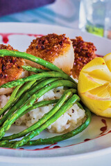 crusted scallops on a bed of risotto with roasted asparagus