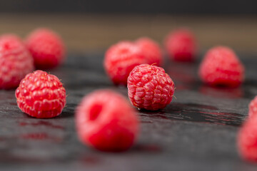 raspberries on the table, the collected amount of ripe raspberries is red close up