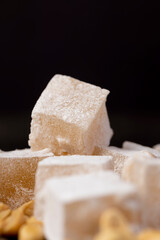 oriental sweets Turkish delight with peanuts on a board, close up, side view