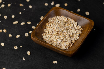 flakes into a bowl, oatmeal for quick cooking of porridge with preservation of useful microelements