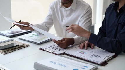 Two Business man team meeting present, investor colleagues discussing new plan financial graph data, analysis with laptop and digital tablet at work place - Powered by Adobe