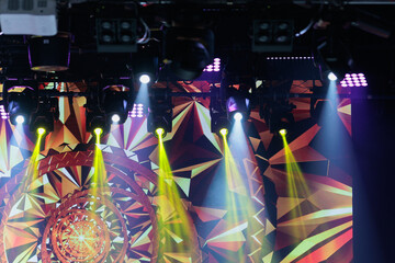 An empty stage of the theater, lit by spotlights and smoke before the performance