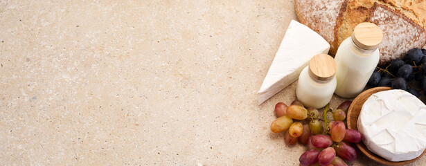 Jewish holiday Shavuot concept. Grains, milk and cheese on travertini stone background