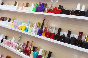 Stand with colourful glass bottles in cosmetic store