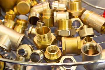 Assortment of brass water fittings on a window in a store