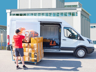 Courier loading packages into delivery van outside industrial warehouse, representing shipping, logistics and express delivery service. – Delivery, Logistics, Transportation, Courier Service.