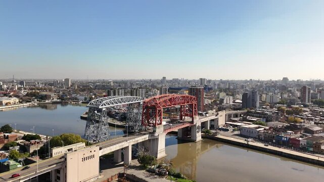Panoramic view of the city of Buenos Aires from the neighborhood of La Boca. Camera hovers orbiting from the bridges over the riachuelo