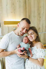 New parents joyfully celebrate the arrival of their newborn in a bright hospital rooma heartwarming...