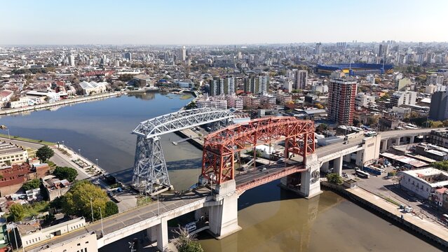Panoramic view of the city of Buenos Aires from the neighborhood of La Boca. Camera hovers orbiting from the bridges over the riachuelo