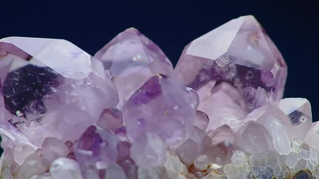 Amethyst crystals in closeup view against dark background  