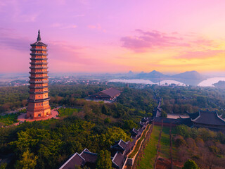 Scenic sunset over bai dinh pagoda in Ninh Binh, Vietnam landscape with temple and mountains