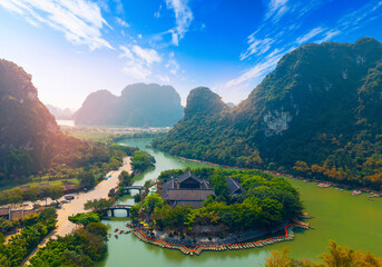 Scenic landscape of Ninh Binh Vietnam with lush mountains and river, travel landmark of Viet