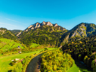 Peak Tri Koruny or Trzy Korony during day with green meadow and trees in spring. Pieniny National park in Slovakia and Poland . © Zedspider