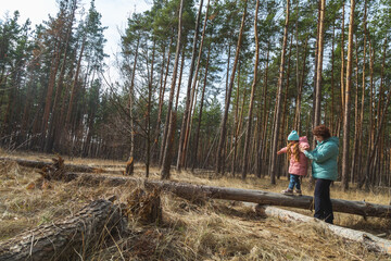 grandmother with granddaughter walking and playing in nature in the forest