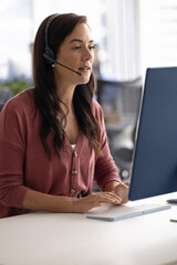 Call center. Vertical photo busy millennial female customer support manager in headset with...